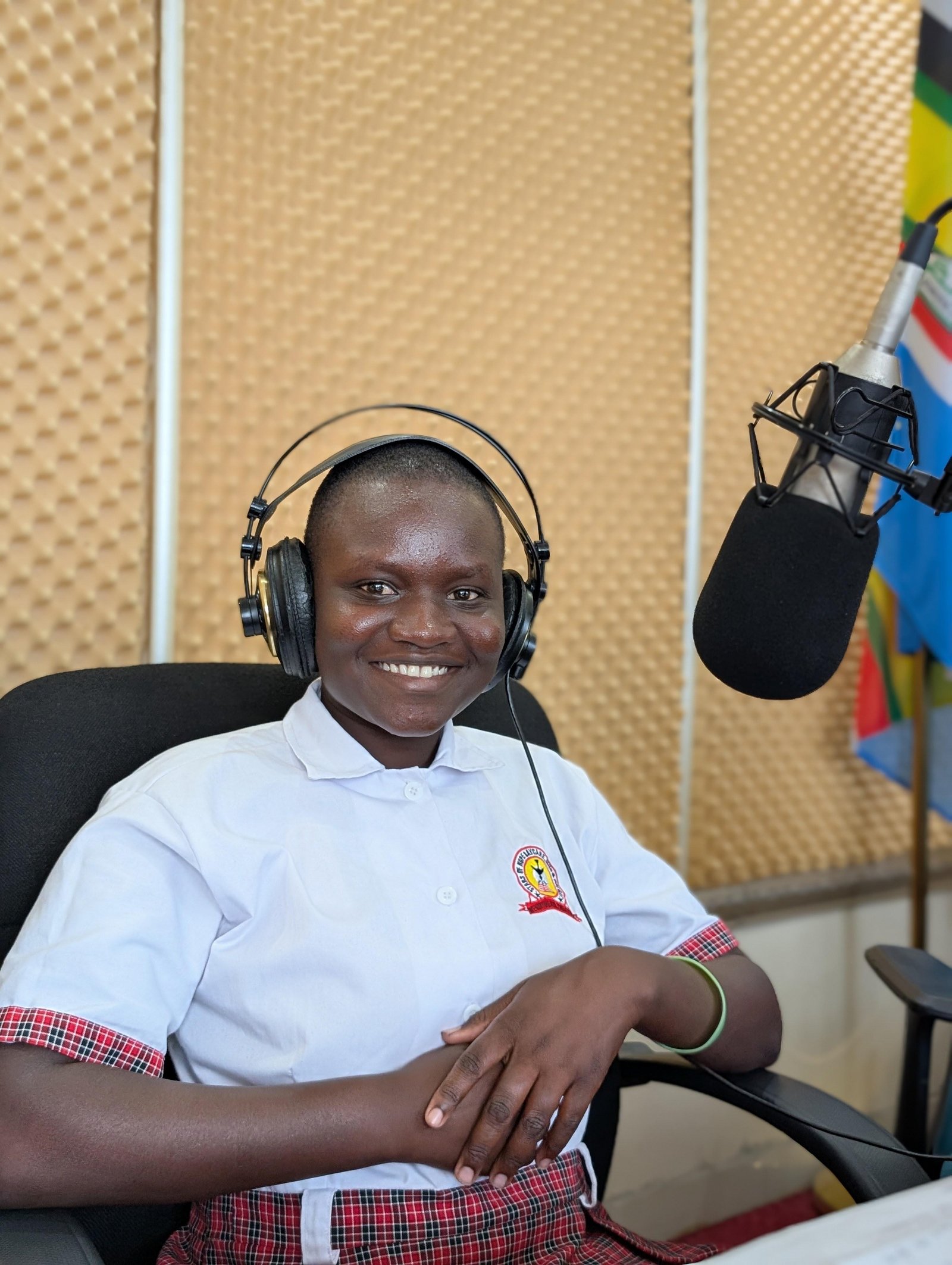 A child from Tower of Hope smiling at a radio station